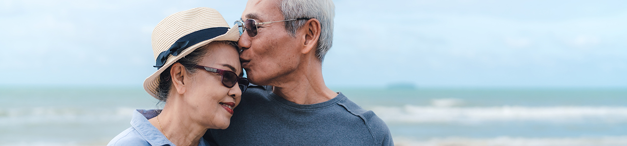 Couple in their 60s on beach together