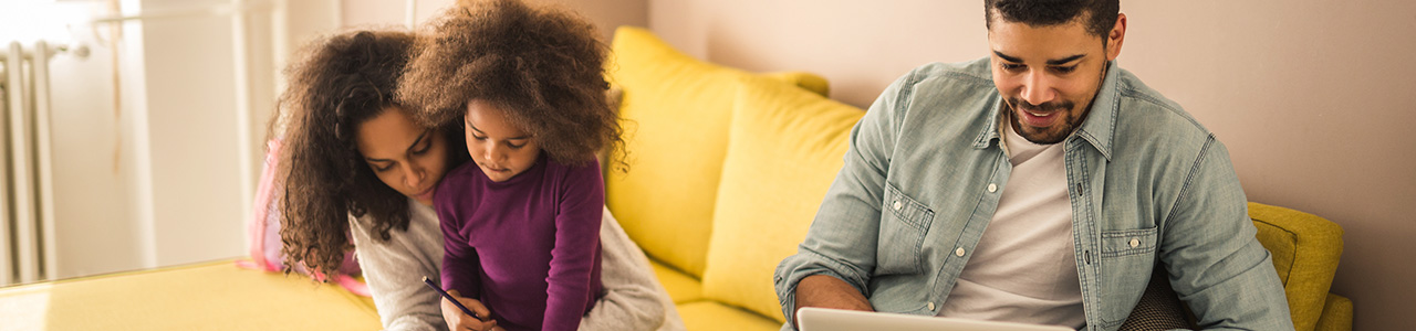 Young family in living room with laptop