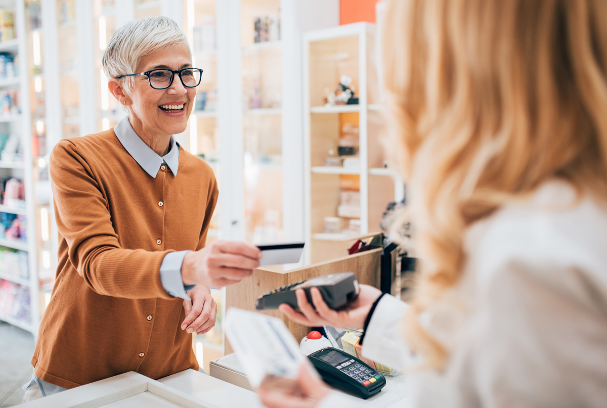 Woman using debit card at a convenience store